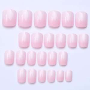 Flat lay of 24 pieces pink gradient press-on nails in various sizes for manicure