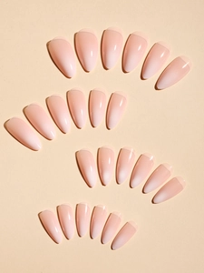 Macro detail of nude gradient press-on nails with shiny finish and French tips