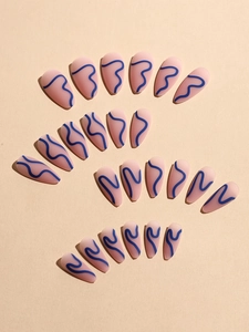 Close-up of matte almond press-on nails with pink base and blue wave art patterns