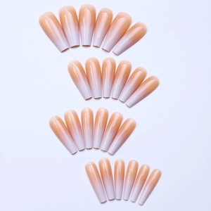 Macro detail of long coffin ombre press-on nails with nude pink to white gradient finish
