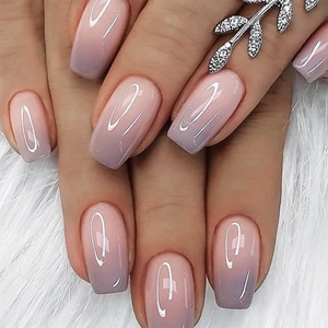 Close-up of pink to purple ombre long coffin press-on nails with glossy finish