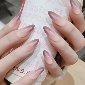 Detail of almond-shaped gradient nails with glossy finish in deep purple and soft pink