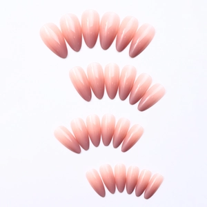 Macro view of long almond-shaped press-on nails with glossy pink ombre gradient