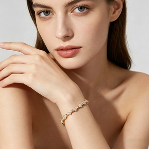 Close-up of gold flower chain bracelet with sparkling zircon stones on a model's wrist
