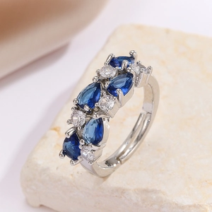 Silver adjustable ring with teardrop blue stones and white zircons on stone base