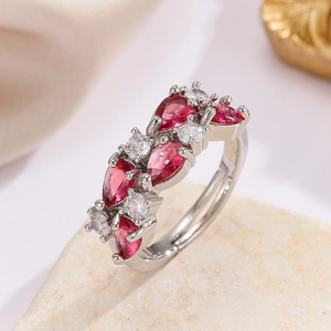 Macro detail of adjustable silver ring featuring teardrop red and white crystals
