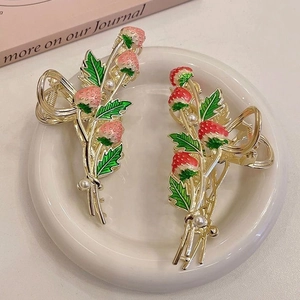 Elegant strawberry hair claw set with gold finish, red enamel, and pearls for women