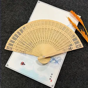 Premium 8-inch sandalwood folding fan with intricate hollow design for wedding favors