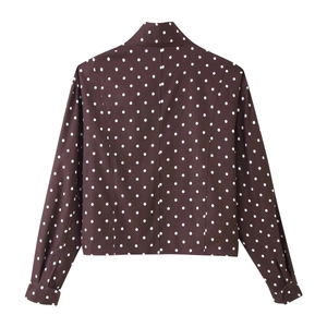 Detailed back view of a brown polka dot long-sleeved jacket with a stand-up collar.