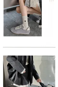 Vue détaillée de la chaussette en maille crème avec cœur brodé noir et bord roulé