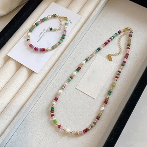 Colorful natural stone and freshwater pearl necklace set with golden bohemian accents