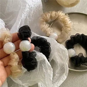 Elegant pleated mesh hair scrunchie with large iridescent pearl bead in gold and black