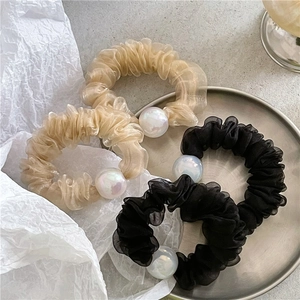 Sheer mesh scrunchies with iridescent pearl accents in black and champagne colors