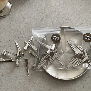 Detail of silver metal duckbill hair clips with professional hand made gift packaging