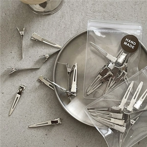 Silver metal hair clips set with 10 duckbill clips in handmade packaging on metal tray