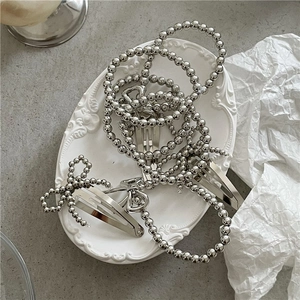 Silver bead bow hair clips and ponytail holders set in a minimalist metallic aesthetic