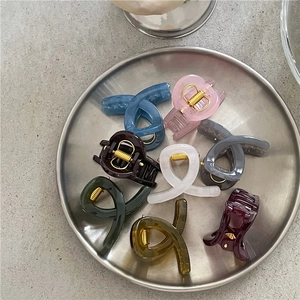 Close-up of colorful jelly texture cross hair claws in a modern metal tray display