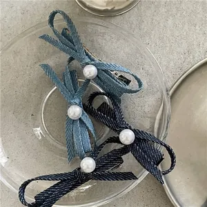 Chic denim bow hair clips with white faux pearls and metal duckbill clips for women