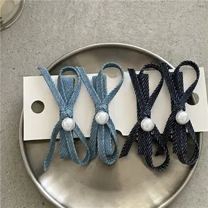 Denim bow hair clip set with faux pearl accents in light and dark blue shades