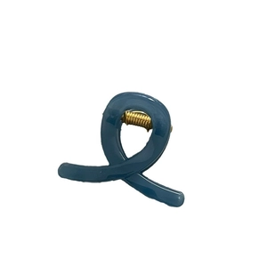 Glossy blue resin hair claw clip with modern twisted design and golden metal spring