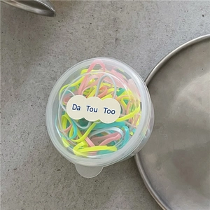 Dettaglio di elastici colorati per bambini in una scatola trasparente con coperchio