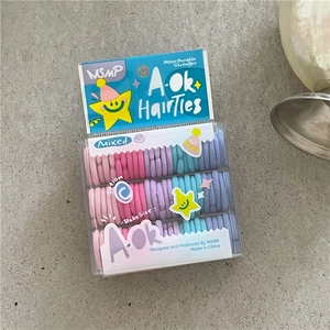 Detailed view of colorful elastic hair bands for babies in a clear plastic storage box