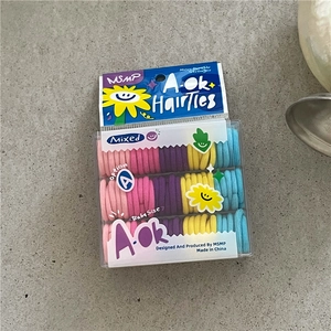 Close-up of colorful elastic hair bands for toddlers in a transparent plastic box packaging