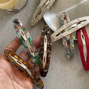 Elegant oval acetate hair clips in marble and tortoiseshell patterns for women