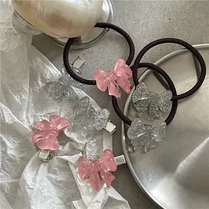 Detailed set of glittery resin bow hair ties and clips in pink and transparent colors