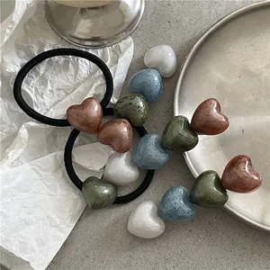 Set of minimalist heart-shaped hair ties with high-elasticity black bands in assorted colors