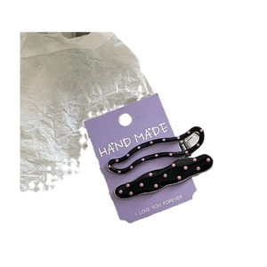 Sweet cream style wavy alloy hairpins with pink polka dots on purple display card