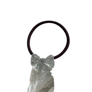 Sparkling silver glitter bow hair tie with crystal ice-cracked texture on dark band