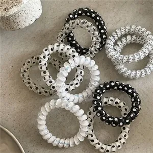 Set of polka dot and floral spiral hair ties in black, white, and transparent styles