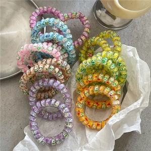 Colorful spiral telephone cord hair ties in romantic spring colors for ponytails