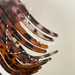 Detail shot of vintage leopard print resin headbands with polished tortoise texture