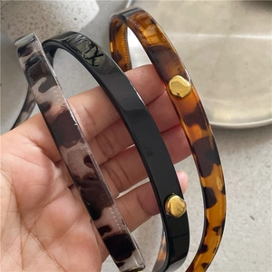 Three-piece retro leopard print headbands with golden alloy accents in black and brown