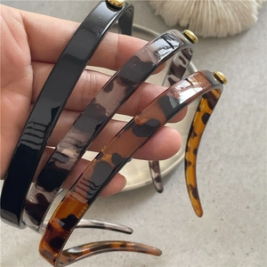 Three-piece retro leopard print and black plastic headbands with gold alloy rivet accents