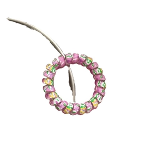 Colorful spiral telephone cord hair tie with pink and green marble pattern for women