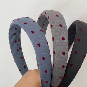 Detail showing red flocked heart pattern on thick fabric sponge headband set