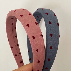Detail of pink and blue padded fabric headbands with red heart prints and textures