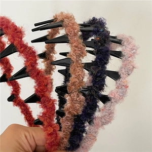 Close-up of wavy plush headbands with non-slip teeth in red, brown, purple and pink