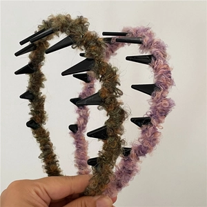 Detail of colorful plush headbands with black cone spikes and non-slip texture