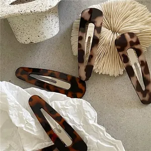 Set of four vintage leopard print resin hair clips with silver metal snap fasteners