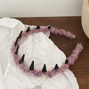 Detail of pink and purple faux shearling headband with black non-slip inner teeth