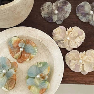 Elegant acetate orchid hair clips with marble texture and pearl center in multi-color set