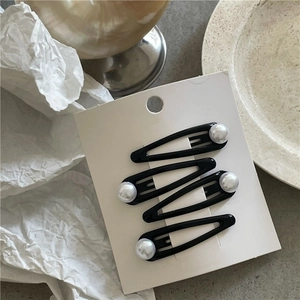 Detailed view of four black drip oil waterdrop BB clips with elegant white pearls