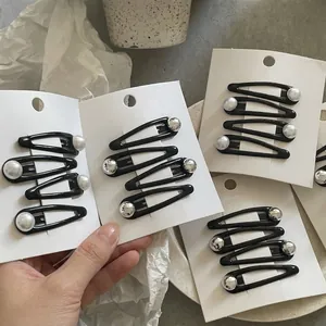 Set of four black drop oil BB clips with white pearl accents on display cards