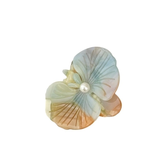 Elegant acetate orchid flower hair clip with gradient colors and a faux pearl center