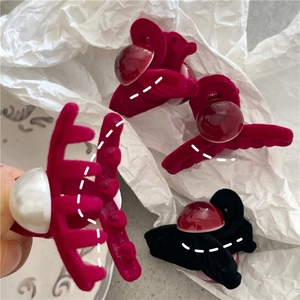 Detail of velvet flocked mini cross hair claws with elegant faux pearl embellishments