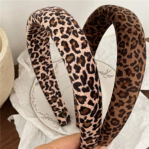 Detail view of two vintage leopard print padded headbands in light and dark brown tones